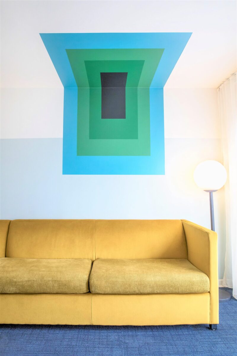 couch and mural artwork in room